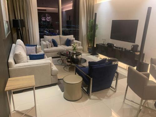 リヤドにあるبرج داماك الرياض DAMAC Towers Riyadhのソファ2つとテレビのあるリビングルーム