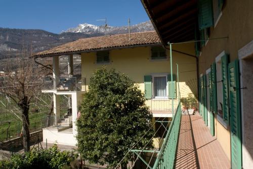 a house with a tree on the balcony of it at Casa Del Noce in Rovereto