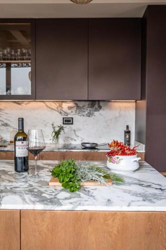 a kitchen counter with a bottle of wine and a glass at Tenuta Zamparina in Montignoso