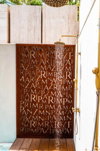 a metal door with writing on it next to a fence at Tenuta Zamparina in Montignoso