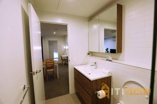 a bathroom with a sink and a mirror at 2bd 2bth - Chic Apt in Woden CBD in Phillip