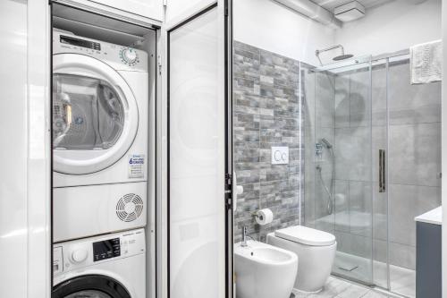 a bathroom with a washing machine and a toilet at Appartamento Terza Strada "3rd Avenue-HolidayHome" in Civitavecchia