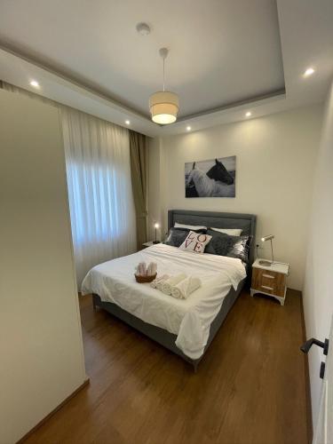 a bedroom with a large bed with white sheets at kestel city 1 in Alanya