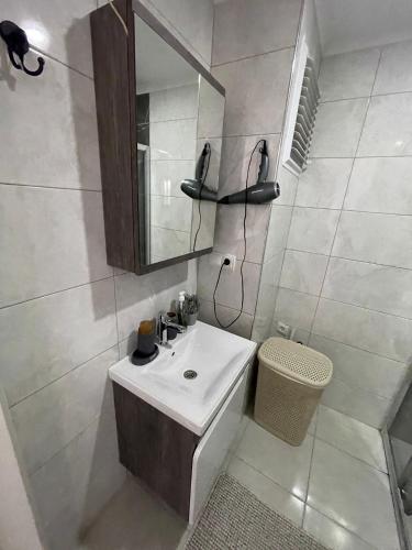 a white bathroom with a sink and a mirror at kestel city 1 in Alanya