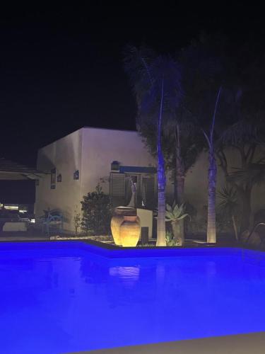 a swimming pool at night with blue lights at Villa Mare Di Montelusa in Agrigento
