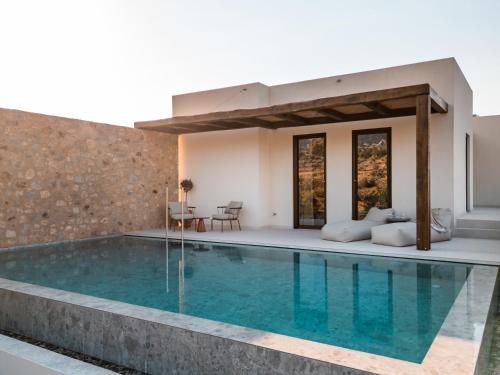a villa with a swimming pool and a house at Noema Luxury Retreat Villas - Adults only in Kos Town