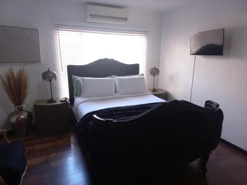 a bedroom with a bed and a window at North Haven Country Estate in Honeydew
