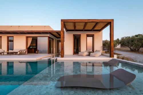 a villa with a pool in front of a house at Noema Luxury Retreat Villas - Adults only in Kos Town
