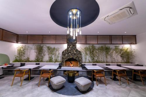 a dining room with tables and a fireplace at Ramitos Hotel in Turunc