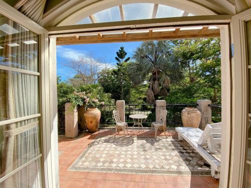 an open door to a patio with a table and chairs at My Chateau Resort in Kenting