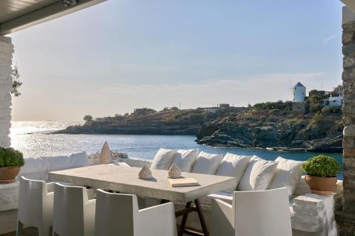 a table and chairs with a view of the ocean at Kea Beachhouse in Koundouros