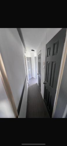 an empty hallway with an open door in a house at Patricias Property in Sheerness