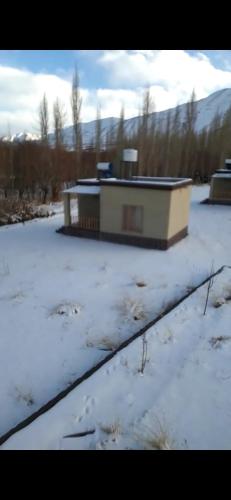 a building sitting on top of a snow covered field at Devaranya Homestay in Leh