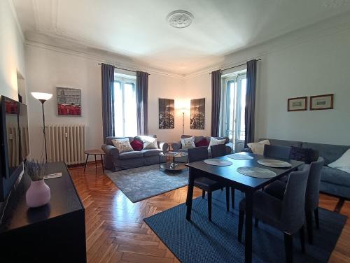 a living room with a table and a couch at SAHI - Residenza Bianca di Savoia in Milan