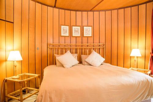 a bedroom with a large bed with two lamps at Kings Lodge Hotel in Hogsback