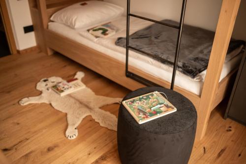 a toy dog on the floor next to a bunk bed at Chalet Lumis in San Vigilio Di Marebbe