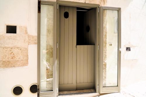 a glass door on a building with a window at La Chianca Rosa - RIFUGIO ROMANTICO ad Ostuni in Ostuni