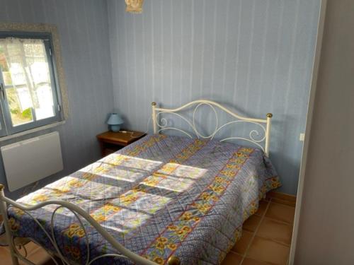 a bedroom with a bed with a quilt on it at Mas du Prescondu in Mirabel-aux-Baronnies