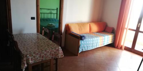 a living room with a chair and a table at Agriturismo Nakelia in Zambrone