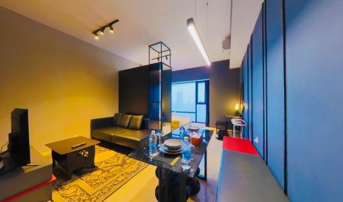 a living room with a table and a couch at Axon Residence KLCC - KL HOME in Kuala Lumpur