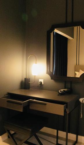 a desk with a lamp on top of it at Axon Residence KLCC - KL HOME in Kuala Lumpur