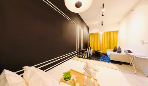 a living room with a black accent wall at Axon Residence KLCC - KL HOME in Kuala Lumpur