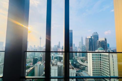 a view of a city skyline from a skyscraper at Axon Residence KLCC - KL HOME in Kuala Lumpur