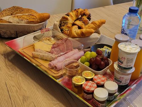 a tray of food with bread and other foods on a table at L'Essentiel bis in Francorchamps