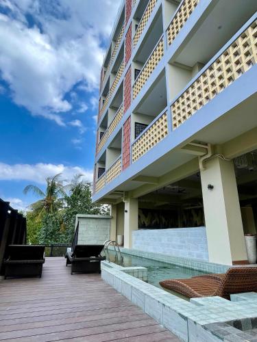 a resort with a swimming pool and a building at Anaya Hotel Canggu in Canggu