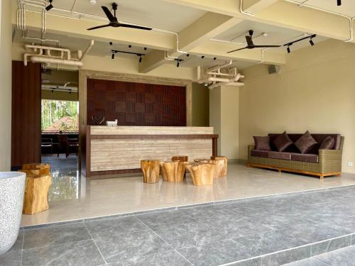 a lobby with a bar with a couch and tables at Anaya Hotel Canggu in Canggu