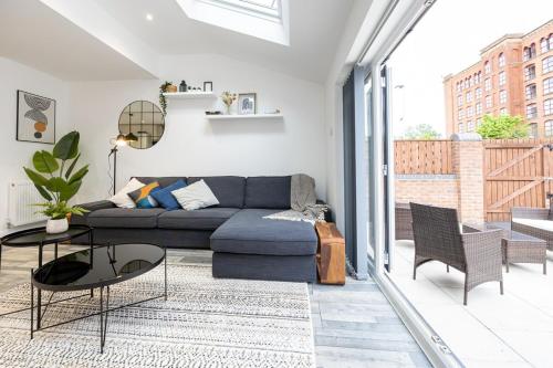 a living room with a couch and a table at The Stanbury Residence by COQOON in Manchester