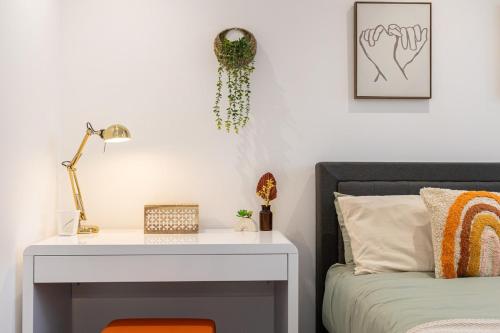 a bedroom with a white desk next to a bed at The Stanbury Residence by COQOON in Manchester