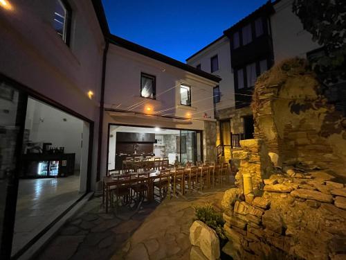 a building with a stone wall and tables and chairs at AGON Ephesus in Selcuk