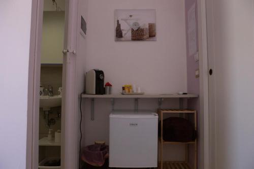 a bathroom with a sink and a small refrigerator at I VACANZIERI in Avola
