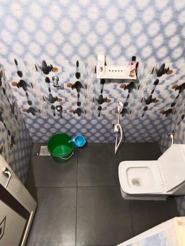 a small bathroom with a toilet and a sink at Casita Greens in Kondotti