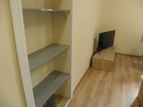 a small room with shelves and a television at Anieli Krzywoń in Szczecin