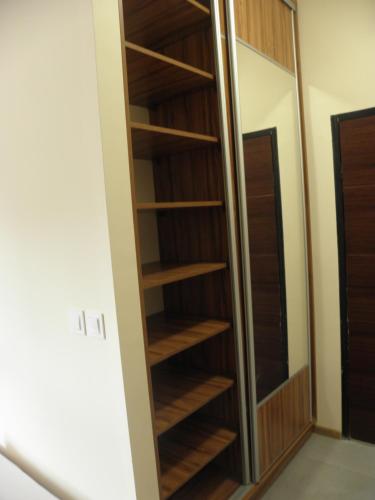a closet in a room with wooden shelves at Anieli Krzywoń in Szczecin