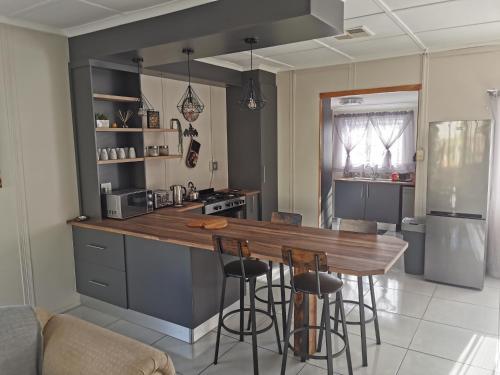 a kitchen with a wooden counter top in a room at Die Windpomp in Vanderkloof