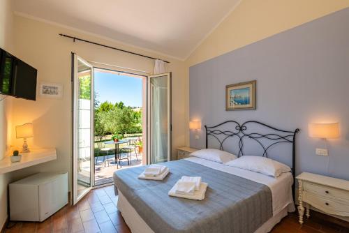 a bedroom with a bed and a sliding glass door at La Visciola - Country House del Conero in Sirolo