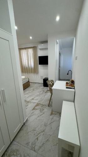 a room with a white desk and a room with a bed at Morgana Sea in Catania