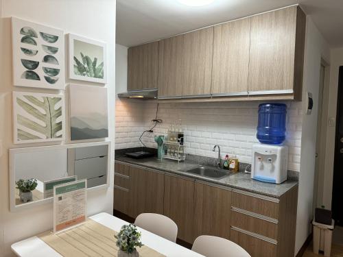 a kitchen with a sink and a counter top at Lian's Haven at Arezzo Place Davao in Davao City