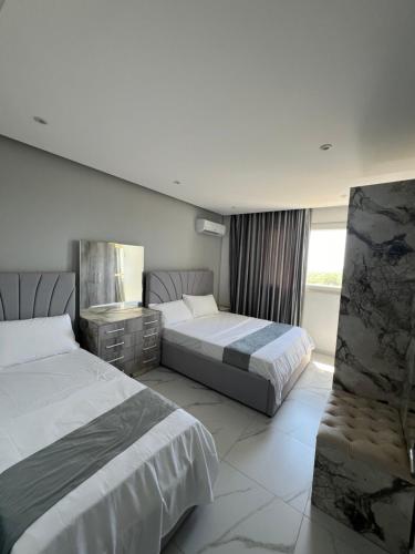 Postel nebo postele na pokoji v ubytování Suli Beach Apartments