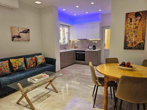 a living room with a blue couch and a table at Guarantee to make you say wow! in Athens