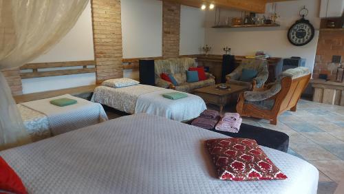 a room with three beds and a living room at Apartamenti Dundaga XXL in Dundaga