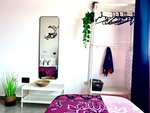 a bedroom with a bed and a mirror at Animoss! Apartments - 10 modern apartments near city center & beach in Santa Maria