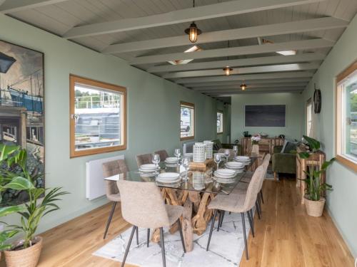 a dining room with a table and chairs at The Pontoon - Pass the Keys in Southend-on-Sea