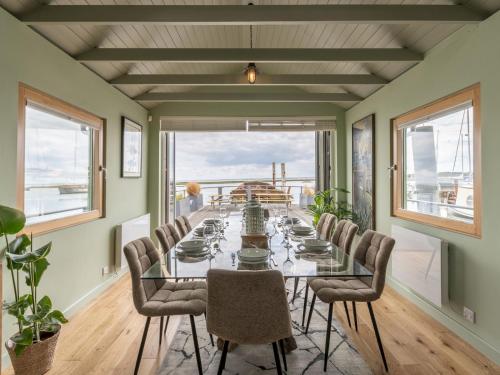a dining room with a long glass table and chairs at The Pontoon - Pass the Keys in Southend-on-Sea
