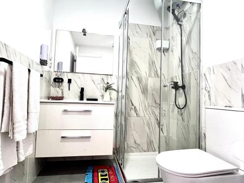 a bathroom with a shower and a toilet at Animoss! Apartments - 10 modern apartments near city center & beach in Santa Maria