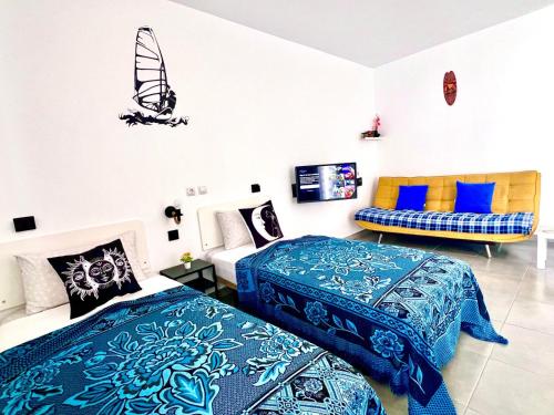a bedroom with two beds and a surfboard on the wall at Animoss! Apartments - 10 modern apartments near city center & beach in Santa Maria