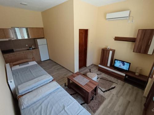 a room with two beds and a tv in it at Apartmani Smiljković90 in Aleksandrovac